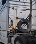 Semi-truck with Safe-Spiral Pre-Cut Hose And Cable Protector Wrap Slick Spiral Shield - Yellow HDPE, ready for transport.