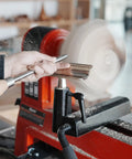 Heavy Duty 1 Inch Diameter Woodturning Lathe Tool Rest Set with steel bar positioned for shaping, showcasing woodturning in action.