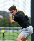 Man using Patented Swing Trainer with 12 Soft Training Balls for Baseball and Softball Build Speed Stay Connected Train Full Body Mechanics