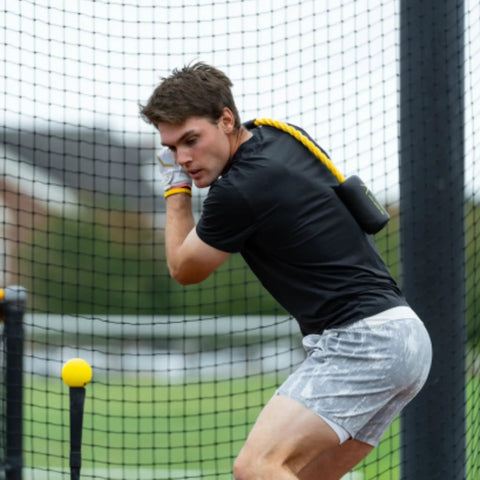 Man using Patented Swing Trainer with 12 Soft Training Balls for Baseball and Softball Build Speed Stay Connected Train Full Body Mechanics