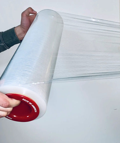 Kickass Ergonomic Plastic Hand Savers For Stretch Film Dispensing Slick Universal Handles Fit 2.95 To 3.05 Inch Cores in use with transparent film