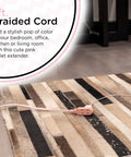 Braided Fabric 3 Outlet Extension Cord With 8 Foot Cable Flat Low Profile 2 Prong Plug Tangle Free Slide To Lock Safety Polarized ETL Listed Light Pink Decor Power Strip For Home Office, shown on carpet next to furniture.