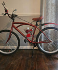 Red bike with motor, featuring large wheels indoors, used with Beefy 26 Inch Bike Rim Wheel Set Built Tough With Double Wall Aluminum Alloy.