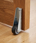 Sturdy 4 Pack Sliding Door Track Rollers For Solid Wood Barn Doors Side Mount Bottom Casters on oak door, showing smooth glide.