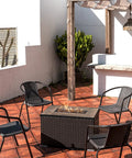 Outdoor patio with propane fire pit, surrounded by chairs, showcasing Copper Reflective Fire Glass 10 Lbs with multicolor shine.