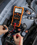 6000-Count Auto-Ranging LCR Meter Multimeter With Inductance Capacitance And Resistance Testing in use on car engine