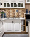 White kitchen cabinets with oil rubbed bronze knobs and back plates, featuring a slick rustic design for practical and decorative use.