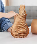 Top Shelf Honeycomb Packing Paper Stretch Roll With Extra Fragile Labels For Moving And Shipping Lightweight Cushion Wrap being pulled from a roll.