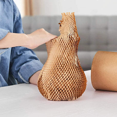 Top Shelf Honeycomb Packing Paper Stretch Roll With Extra Fragile Labels For Moving And Shipping Lightweight Cushion Wrap being pulled from a roll.