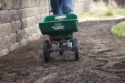 Edge Guard Mini Broadcast Spreader With Calibrated Settings And Wheels, Ideal For Lawns Up To 5,000 Sq Ft spreading on dirt path