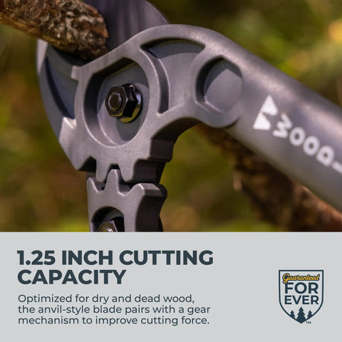 Close-up of Compact 16 Inch Lopper With Gear Assist Anvil Blade cutting dry branch, highlighting 1.25 inch capacity