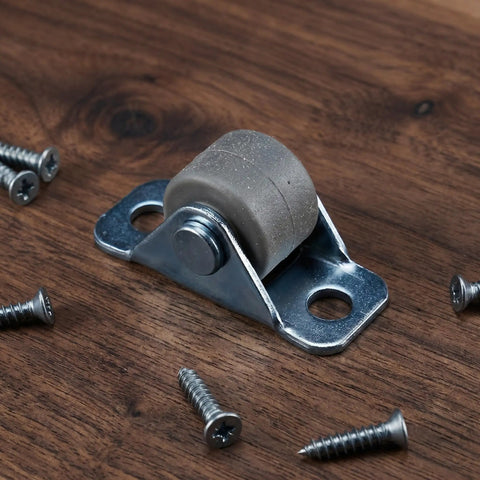 Eight Piece Low Profile Rigid Rubber Caster Wheels Non Swivel Fixed Plate Casters With Silent Rolling And Floor Saving Design For Heavy Furniture Bedroom Appliances And Small Trolleys No Sweat Moving For Your Furniture Everyday on a wooden surface with screws.