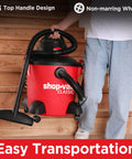 Person carrying 8 Gallon Wet Dry Vacuum With 4.5 Peak HP Motor, 3 In 1 Multi Function, on stairs demonstrating easy transportation.