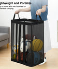 Person holding black Ball Storage Organizer Basket For Garage, Gym, Or Playroom, wall-mounted or freestanding holder with balls