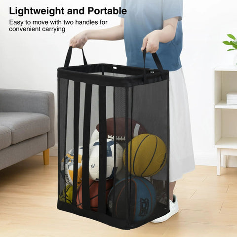 Person holding black Ball Storage Organizer Basket For Garage, Gym, Or Playroom, wall-mounted or freestanding holder with balls