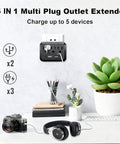 Three Outlet Wall Charger Extender with LED nightlight on wall, charging camera, and headphones next to plant