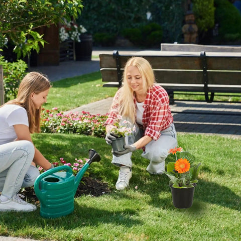 Two people gardening with 100 Packs Of 4 Inch Plastic Nursery Pots With Drainage Holes For Seed Starting And Transplanting Plants