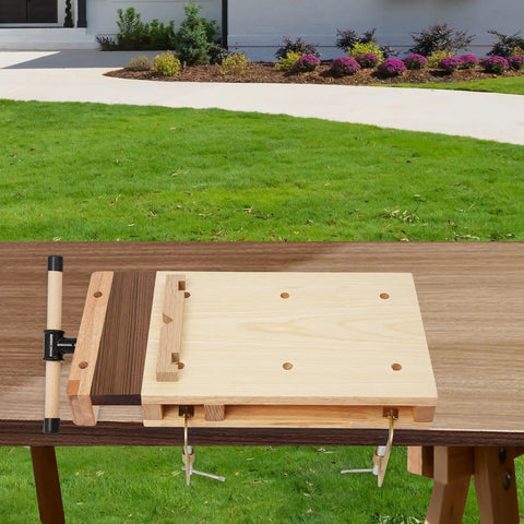 Beefy Portable Wooden Workbench With Woodworking Vise and C Type Clips, showcased outdoors on a green lawn.