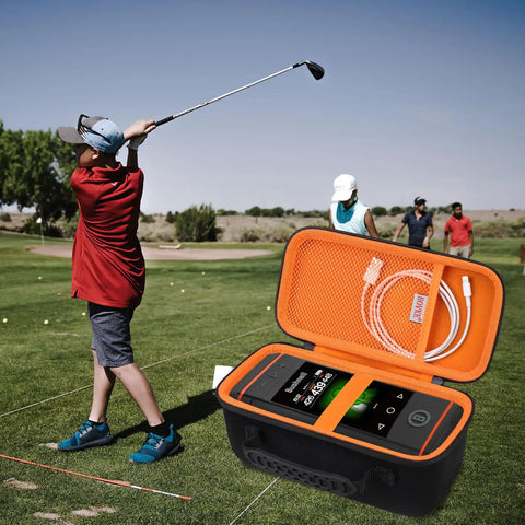 Rugged Carrying Case For Wingman HD GPS Speaker open on golf course with player swinging, showing black and orange protective interior.