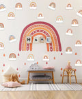 Rainbow Cutouts For Classroom Decor on wall, boho rainbow name tags, cozy kids' playroom with cushions and toys.