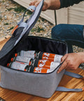 Built Tough Camping Gas Tank Bag with 320D cationic fabric holding gas canisters securely on a wooden table