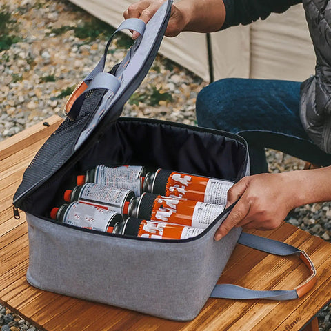 Built Tough Camping Gas Tank Bag with 320D cationic fabric holding gas canisters securely on a wooden table