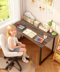 Child sitting at a Compact 32 Inch Computer Desk In Brown With Steel Frame And Adjustable Feet, in home study area.
