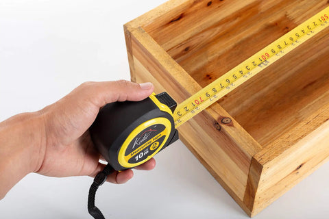 33 Ft Tape Measure With Magnetic Hooks And Fraction Markings measuring wooden box corner