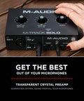 Close-up of M-Track Solo USB Audio Interface for recording with XLR and DI inputs on a wooden surface