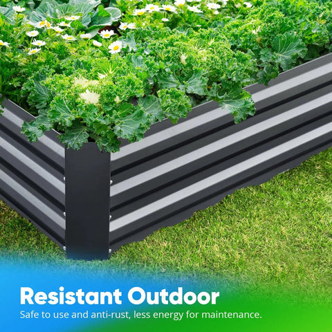 Close-up of a galvanized raised garden bed filled with leafy greens, showing its durable metal construction on grass.
