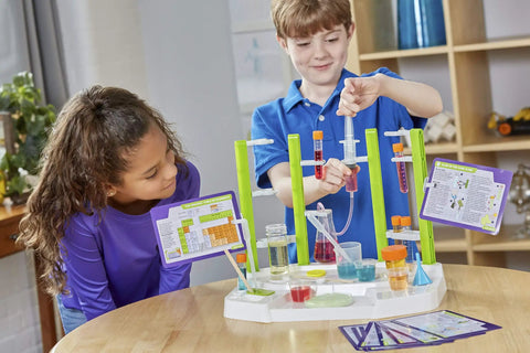 Children using Ooze Labs Chemistry Station Science Kit for Kids with 57 Pieces and 20 Safe Experiments including slime making.