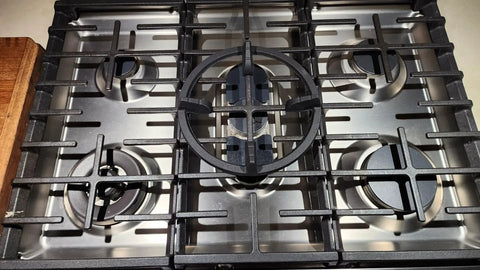 Top view of gas stove with cast iron wok ring support, fits round-bottom woks. Stable high heat cooking base centered on grate.