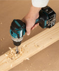Brushless 18V Cordless Drill Driver With 13Mm Keyless Chuck And Dual Speed Gearing drilling into wood with precision, creating wood shavings.
