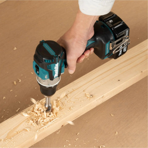 Brushless 18V Cordless Drill Driver With 13Mm Keyless Chuck And Dual Speed Gearing drilling into wood with precision, creating wood shavings.