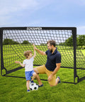 Backyard Kids Soccer Goal Set Two 6x4 Ft Portable Soccer Nets with father and son playing in a grassy park setting