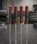 Pro Grade 4 Piece Lock Pick And Hook Tool Set With Comfort Grip for Auto Repair on a workbench, showing ergonomic handles.