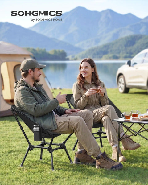 Two people sitting on Portable Camping Chair With 330 Pounds Capacity Lightweight Backpacking Chair by a lake