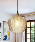Top Shelf Amber Glass Pendant Light With Vintage Gold Trim For Kitchen Island And Dining Area Height Adjustable Cord shines in a cozy dining space.