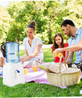 Family enjoying picnic with Portable Cold Water Dispenser For Countertop Space Saving Mini Water Cooler providing hydration