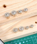 "Handy Doweling Pin Center Drill Set With Sharp Point Transfer Plugs In One Quarter, Five Sixteenths, Three Eighths, And One Half Inch Sizes, Twenty Piece Carbon Steel Doweling Centers For Quick And Precise Woodworking Holes shown on wooden surface"
