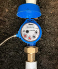 Top view of a blue One Inch Irrigation Flow Meter For Sprinklers With Real Time Water Usage Data And Leak Alerts installed underground.