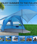 Pop Up Beach Tent With 360 Degree Removable Canopy for 4 to 6 People, set up on grass and sand with open flaps and blue sky.