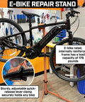 Heavy Duty E Bike Repair Stand With Telescoping Arm 360 Degree Rotating Clamp displayed with a bike in a workshop.