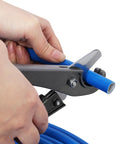 Hands using a cutter on Heavy Duty 1/2 Inch Blue Air Compressor Piping Tube for precise fitting adjustments.