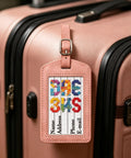 Four Pack No Fuss Needlepoint Luggage Tags Featuring Slick Faux Leather Shell And Crystal Clear Id Window on a pink suitcase.