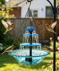 Three Tier Solar Powered Hanging Bird Bath Fountain with cascading water flow, attracting hummingbirds and wild birds in a garden.