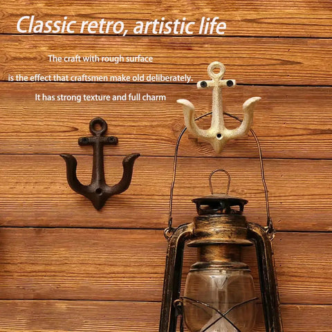 Badass Vintage Cast Iron Nautical Anchor Wall Hooks For Bathrooms And Closets. Two hooks in black and gold on wooden wall.