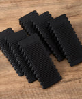 Pack of six Rock Solid Black Rubber Wedge Shims for Furniture Leveling, sturdy 93x40mm tapered anti-slip pads.