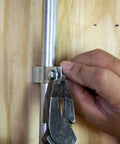Person securing conduit with Bulk Nail Plate One And A Half Inch By Two And A Half Inch Tough As Nails Durable Steel Connector Plate
