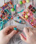 Crafting with the 5 Piece Jewelry Pliers Set For Beading And Wire Wrapping Handy Jewelry Making Tools Kit with colorful beads.